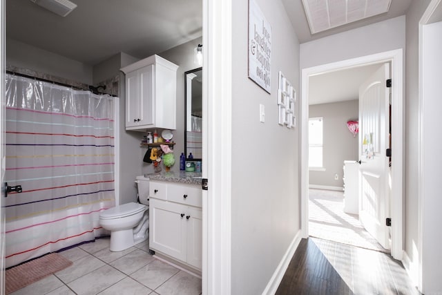 bathroom with baseboards, visible vents, toilet, a shower with curtain, and vanity