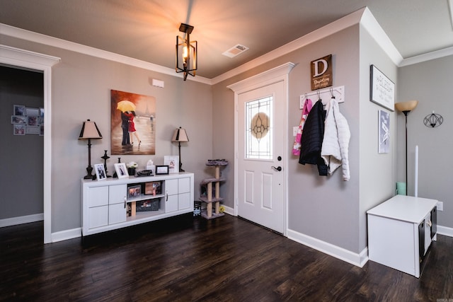 foyer entrance featuring ornamental molding, dark wood-style flooring, visible vents, and baseboards