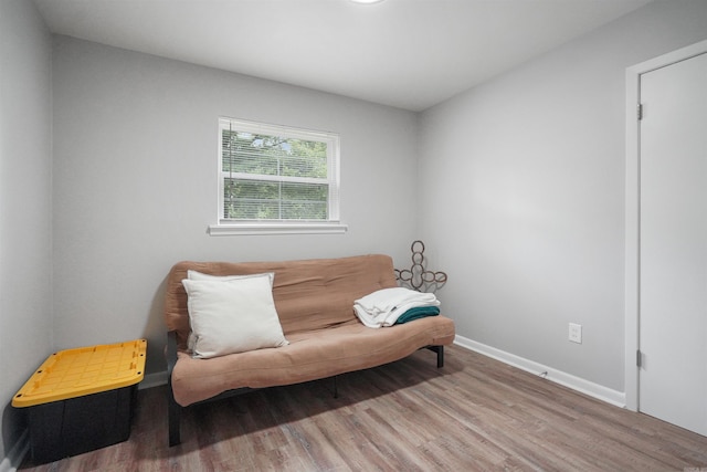 living area featuring baseboards and wood finished floors