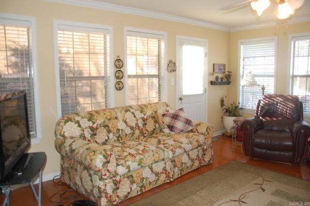 living room featuring a fireplace, wood finished floors, a ceiling fan, and crown molding