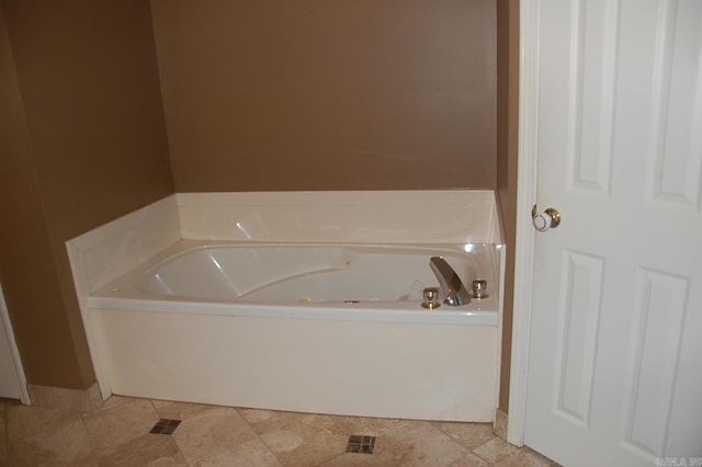 bathroom with a garden tub and tile patterned floors