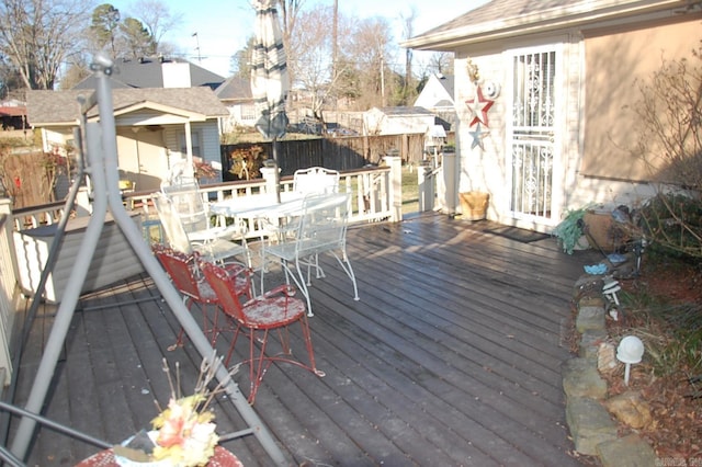 wooden deck with fence and outdoor dining space