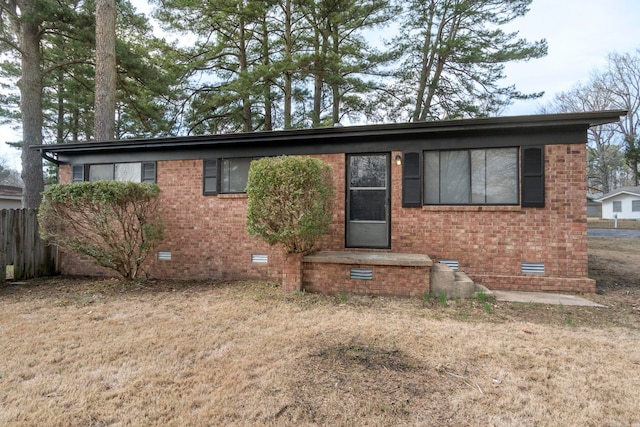 ranch-style house featuring crawl space, fence, a front lawn, and brick siding