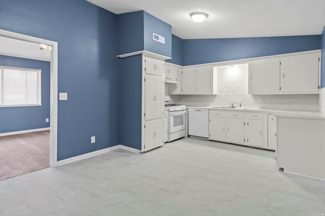 kitchen featuring white appliances, white cabinetry, visible vents, and vaulted ceiling