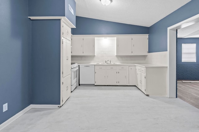 kitchen featuring lofted ceiling, white appliances, a sink, white cabinetry, and light countertops