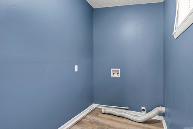 laundry room with hookup for a washing machine, electric dryer hookup, wood finished floors, laundry area, and baseboards