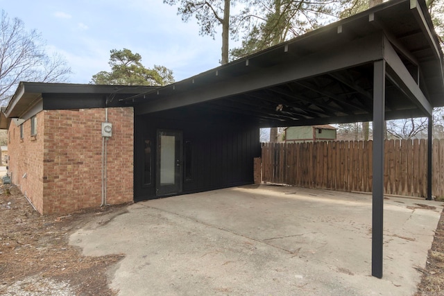 view of property exterior with brick siding and fence