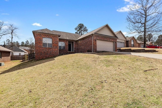 ranch-style house featuring brick siding, concrete driveway, an attached garage, a front yard, and fence