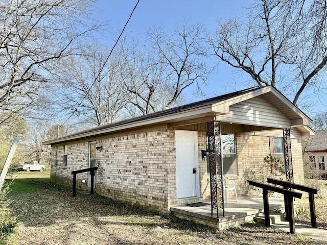 exterior space featuring brick siding