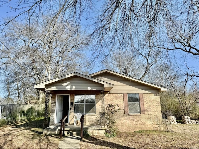 view of front of home with brick siding and a porch