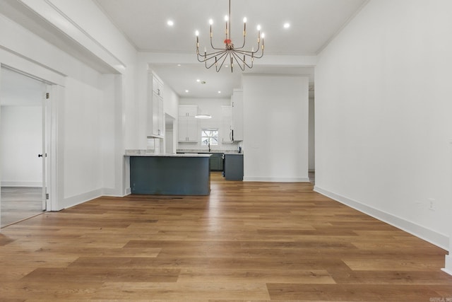 interior space featuring light wood finished floors, baseboards, a chandelier, and recessed lighting