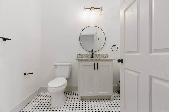 bathroom featuring tile patterned floors, vanity, toilet, and baseboards