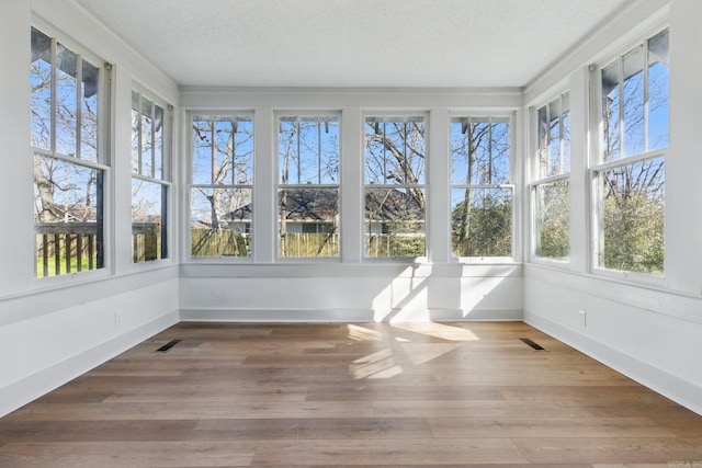 unfurnished sunroom with visible vents