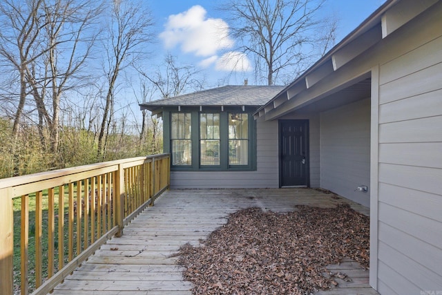 wooden deck with a sunroom