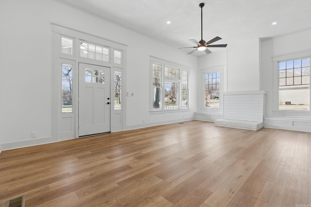 foyer featuring light wood-type flooring, baseboards, visible vents, and recessed lighting