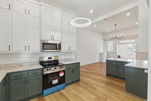 kitchen with tasteful backsplash, baseboards, light wood-style flooring, stainless steel appliances, and green cabinetry