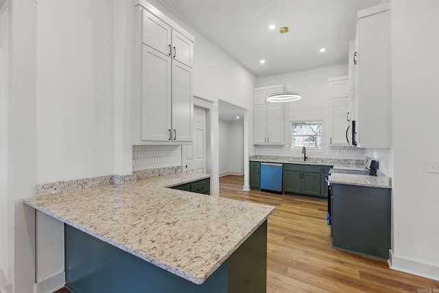 kitchen featuring a peninsula, light wood finished floors, white cabinetry, and dishwasher