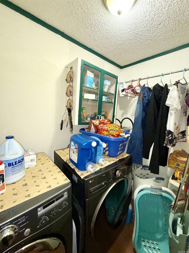 laundry room featuring a textured ceiling, laundry area, wood finished floors, and washing machine and dryer