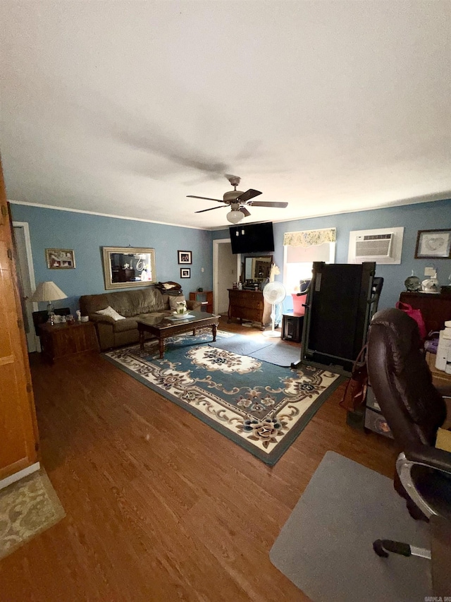 living area featuring a ceiling fan, an AC wall unit, and wood finished floors