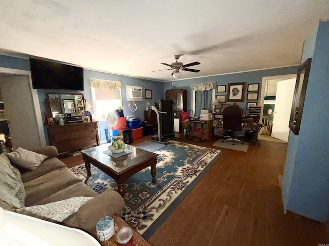 living area featuring a wall unit AC, ceiling fan, and wood finished floors