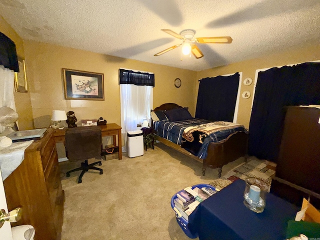 bedroom with a textured ceiling, a ceiling fan, and light colored carpet