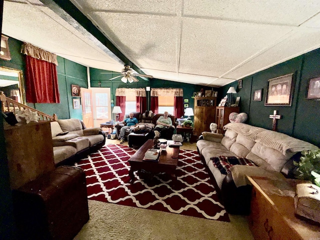 living room featuring carpet floors, vaulted ceiling with beams, a textured ceiling, and ceiling fan