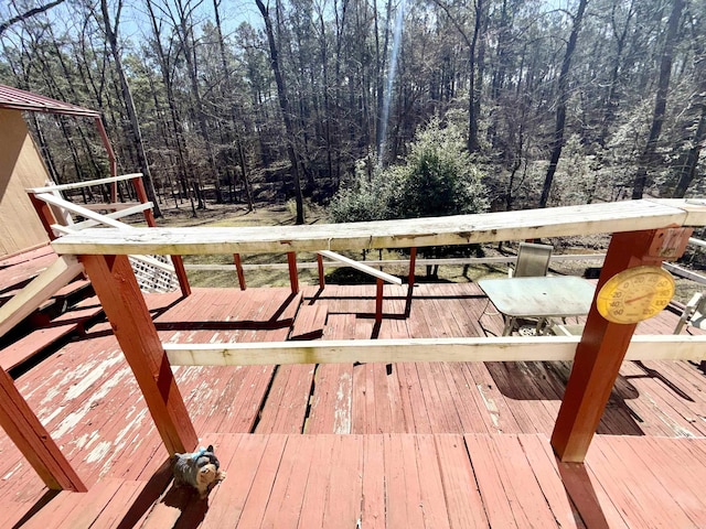 wooden deck with a forest view