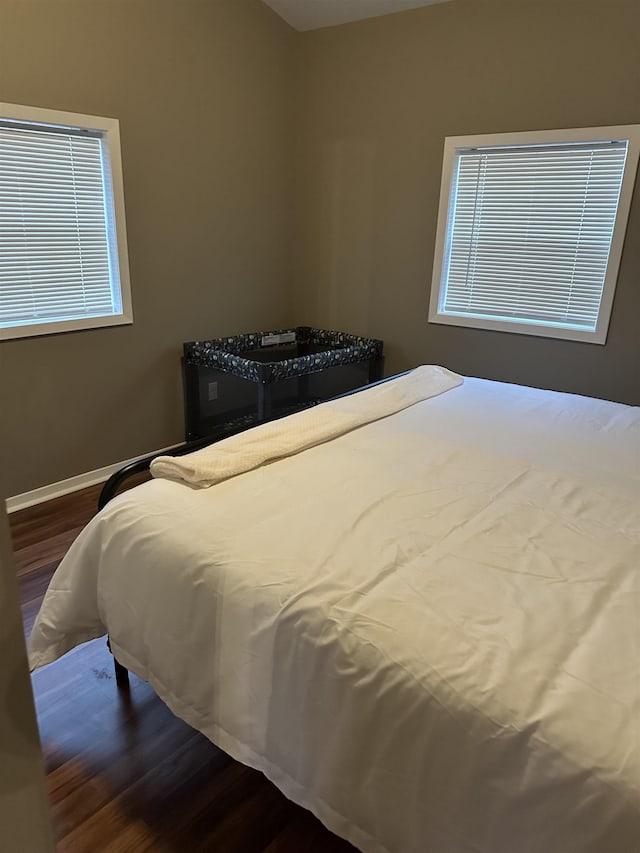 bedroom featuring wood finished floors and baseboards