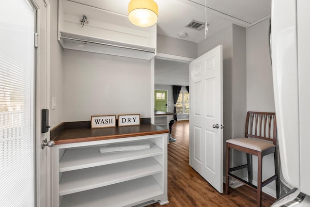 spacious closet with dark wood-style floors, attic access, and visible vents