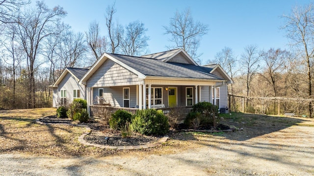 view of front of house with a porch, driveway, and a shingled roof