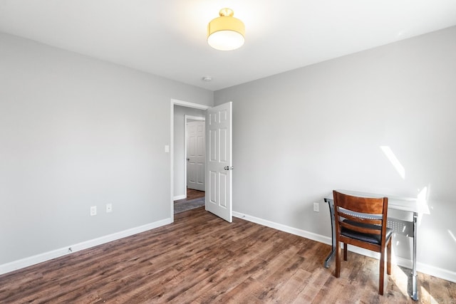 interior space featuring baseboards and wood finished floors