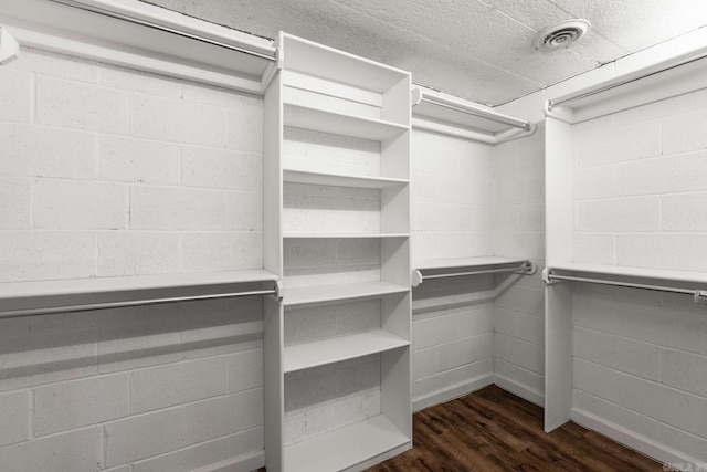 walk in closet featuring dark wood-style floors and visible vents