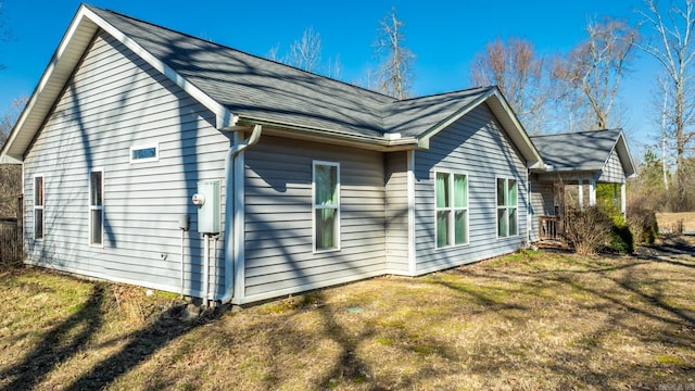 view of side of home with a yard