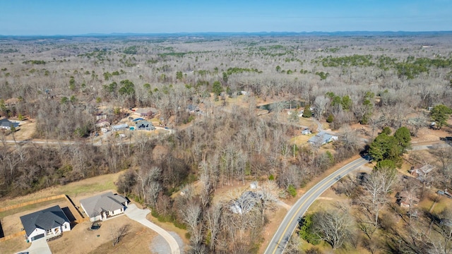 birds eye view of property featuring a view of trees