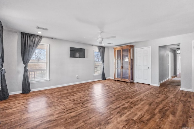 unfurnished living room with a ceiling fan, baseboards, visible vents, and wood finished floors