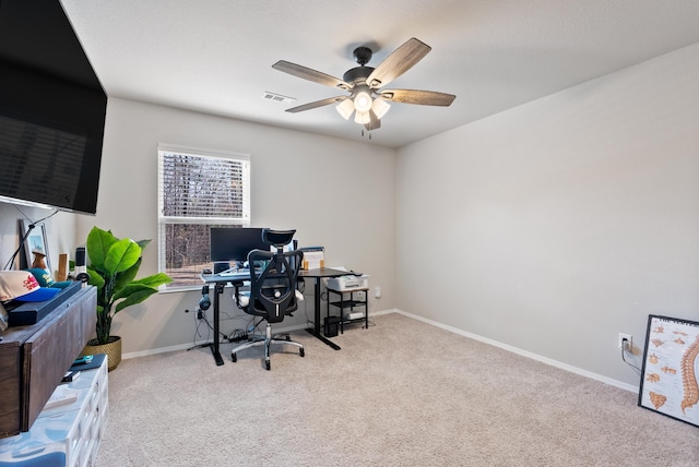 carpeted office with ceiling fan, visible vents, and baseboards