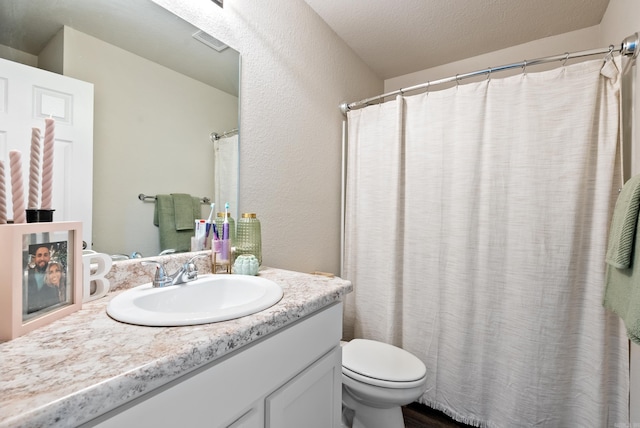 full bathroom featuring toilet, visible vents, and vanity