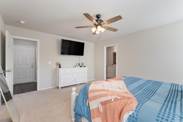 bedroom with ceiling fan, carpet floors, ensuite bathroom, and baseboards