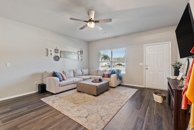 living room with a ceiling fan, visible vents, baseboards, and dark wood-style flooring