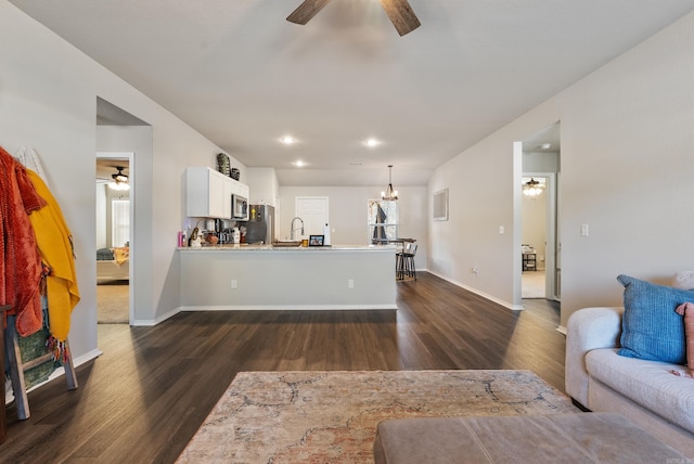 living room with recessed lighting, dark wood finished floors, a ceiling fan, and baseboards