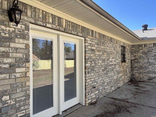 property entrance with brick siding