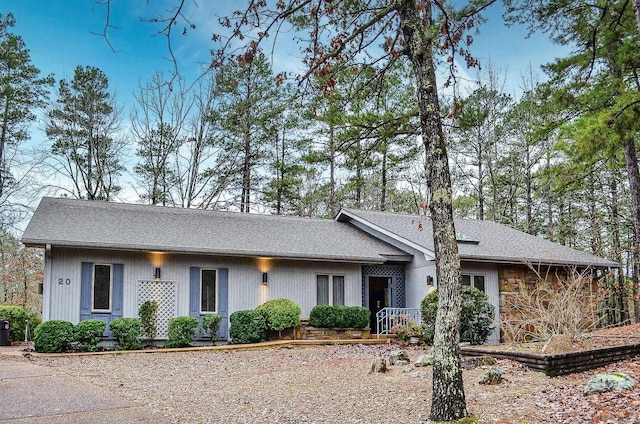 ranch-style home with a shingled roof