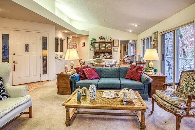 living area with light tile patterned flooring, vaulted ceiling, a textured ceiling, and light colored carpet