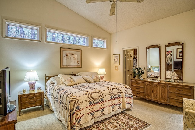 bedroom with a ceiling fan, lofted ceiling, light colored carpet, and a textured ceiling