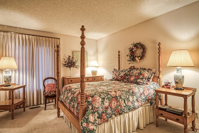 bedroom featuring a textured ceiling, carpet flooring, and visible vents