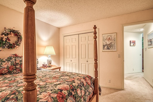 carpeted bedroom with a closet, a textured ceiling, and baseboards