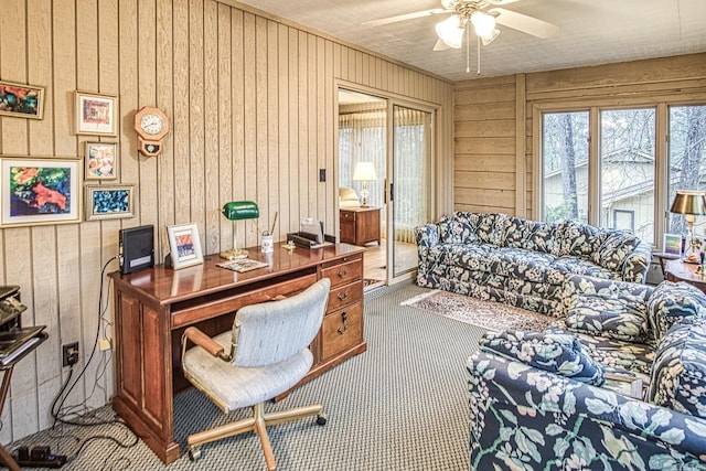 carpeted office space featuring a ceiling fan