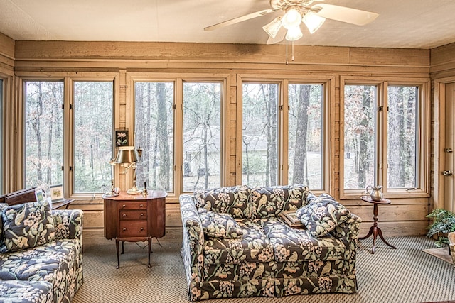 sunroom / solarium with a ceiling fan