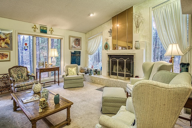 sitting room featuring a textured ceiling, a premium fireplace, and carpet flooring