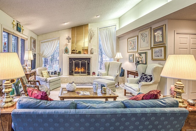 living room featuring a healthy amount of sunlight, a fireplace, and a textured ceiling